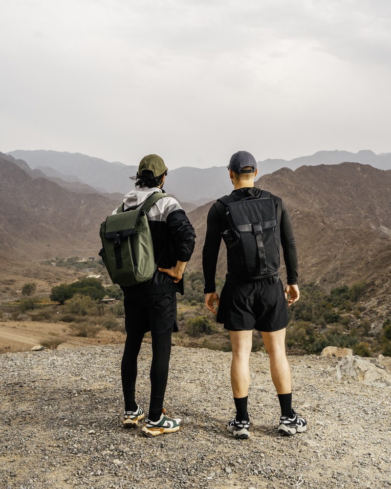 Two hikers looking out over the mountains